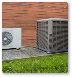 mini split and heat pump unit sitting next to each other outside on a slab of concrete