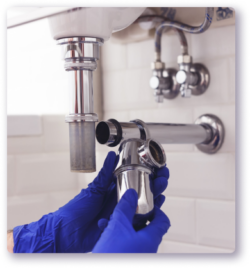 tech installing a pipe for a bathroom sink