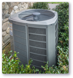HVAC unit outside surrounded by bushes